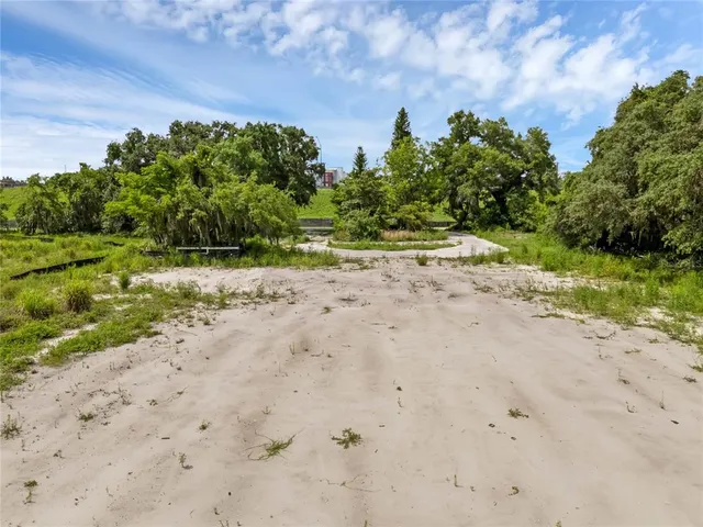 a view of a dirt road with a building in the background