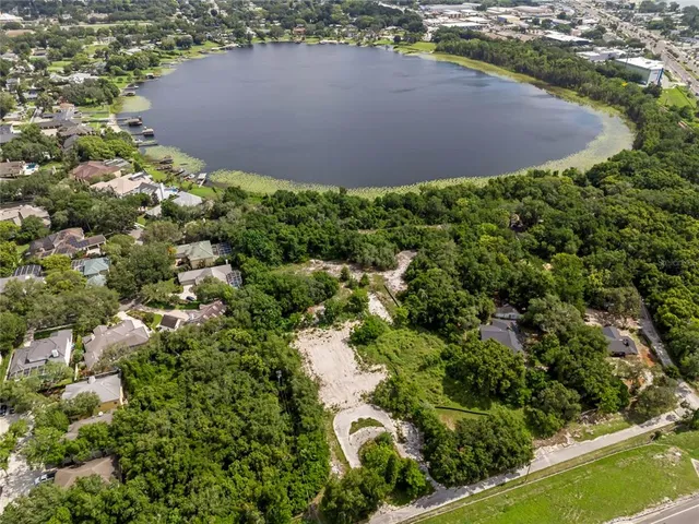 an aerial view of residential houses with outdoor space and street view
