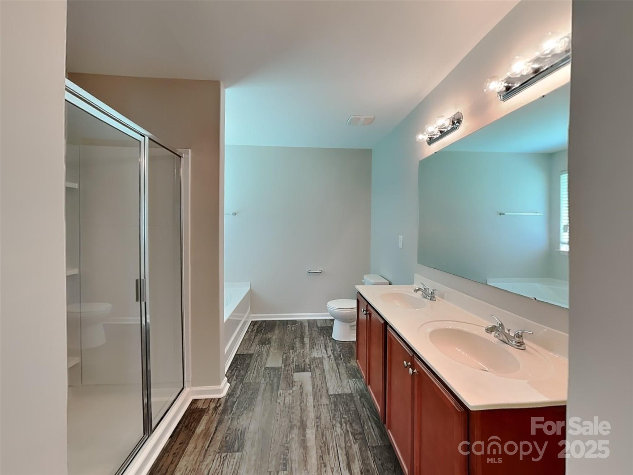 608 Hunley Street Monroe, NC 28112 - Photo 13 of 21 a bathroom with a sink a mirror and a shower
