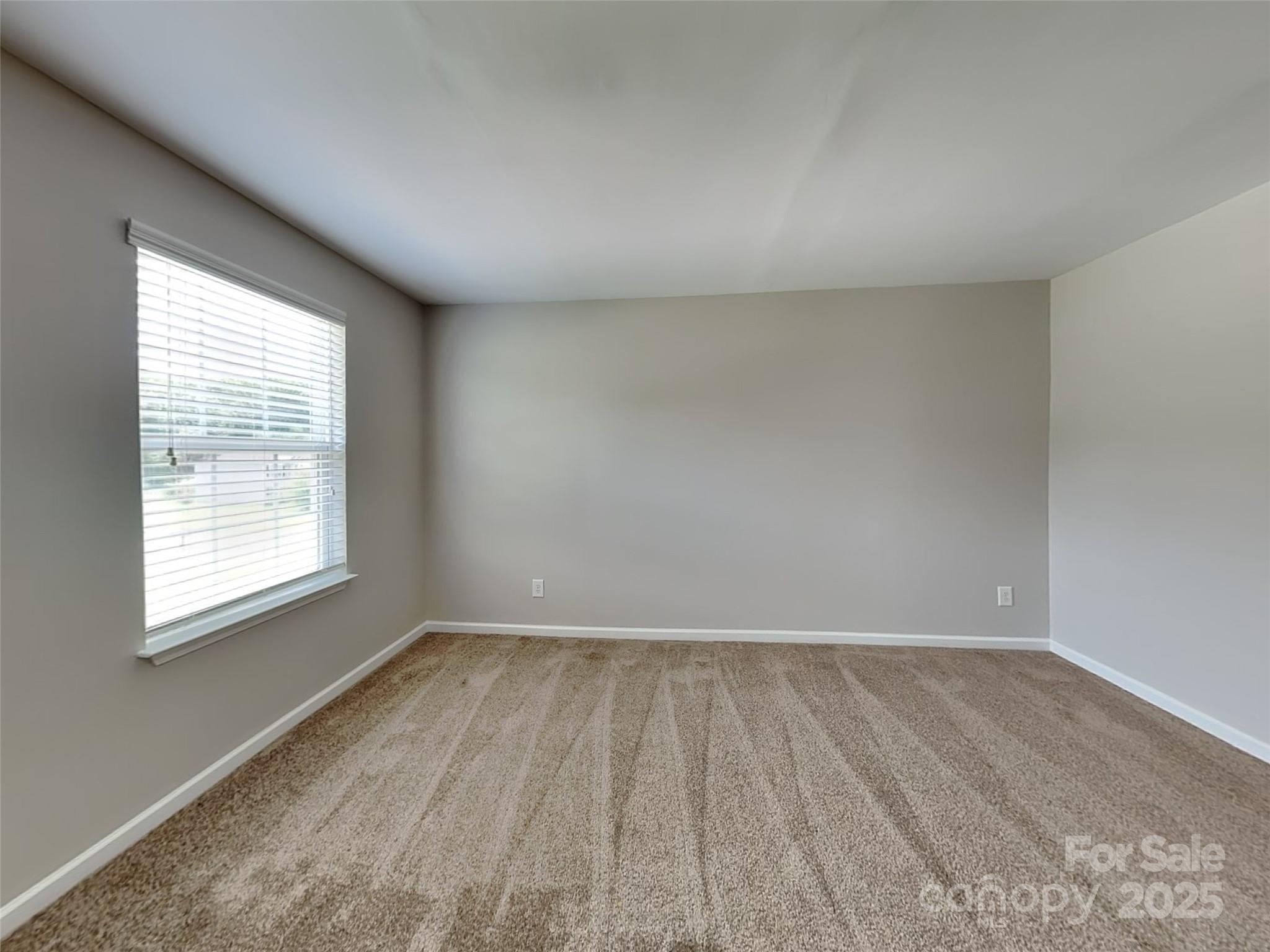 608 Hunley Street Monroe, NC 28112 - Photo 17 of 21 an empty room with wooden floor and windows