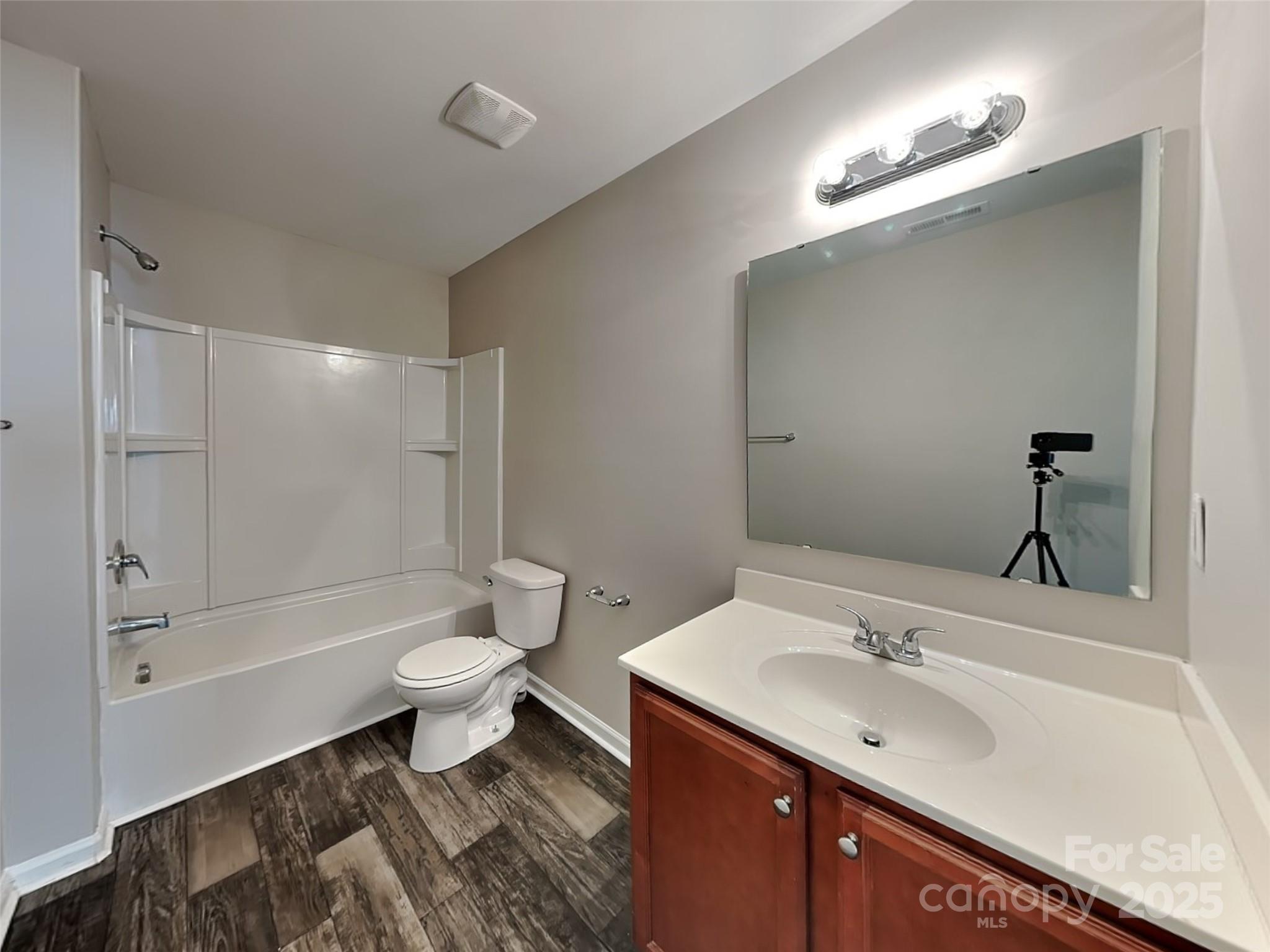 608 Hunley Street Monroe, NC 28112 - Photo 19 of 21 a bathroom with a sink toilet a shower and a mirror