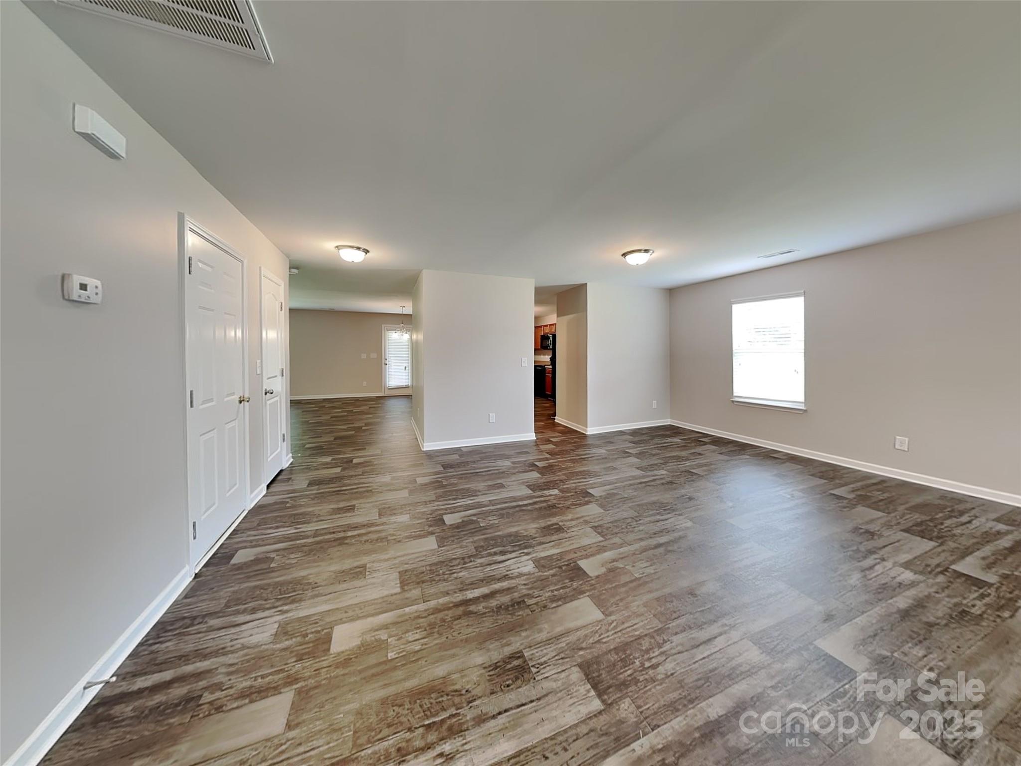 608 Hunley Street Monroe, NC 28112 - Photo 2 of 21 a view of empty room with wooden floor and window