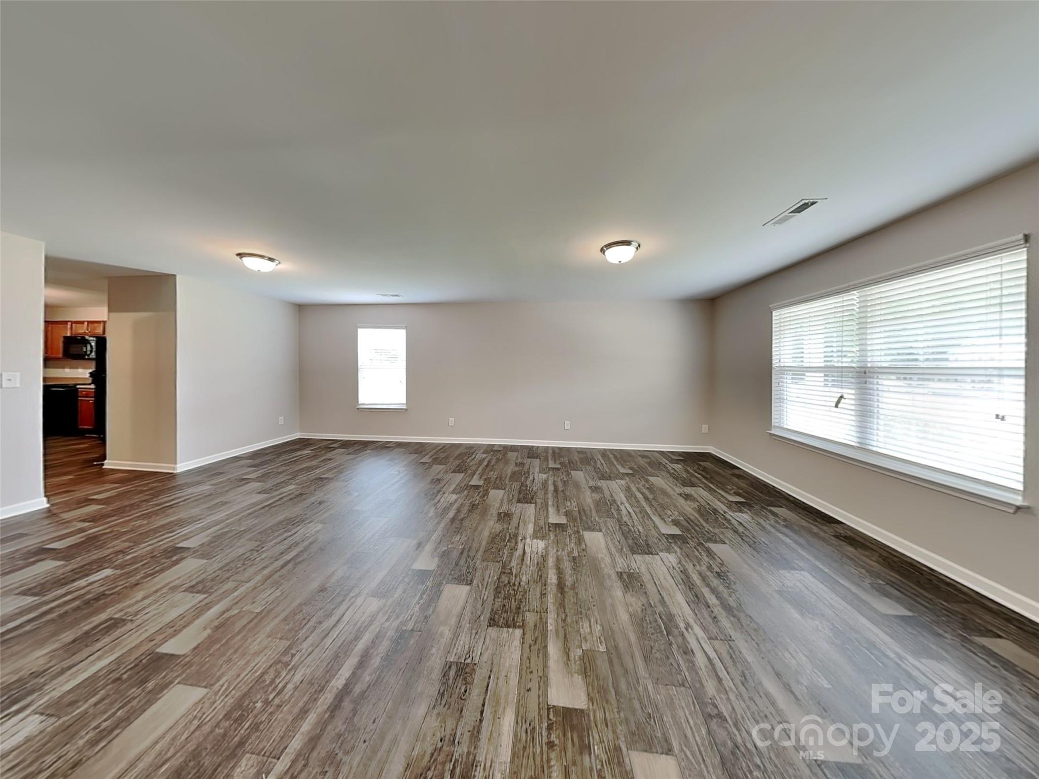 608 Hunley Street Monroe, NC 28112 - Photo 3 of 21 wooden floor in an empty room with a window