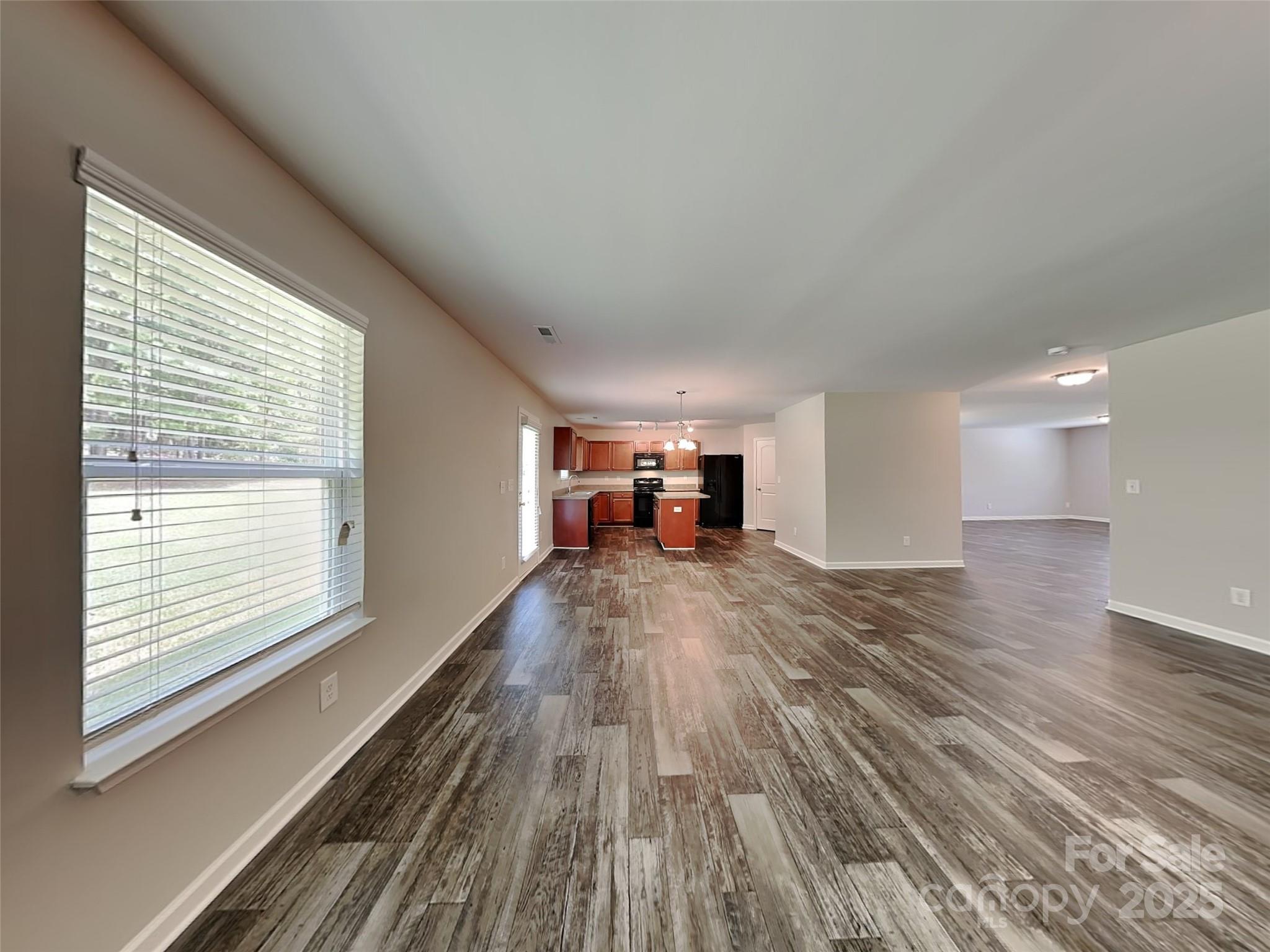 608 Hunley Street Monroe, NC 28112 - Photo 7 of 21 a view of empty room with wooden floor and fan