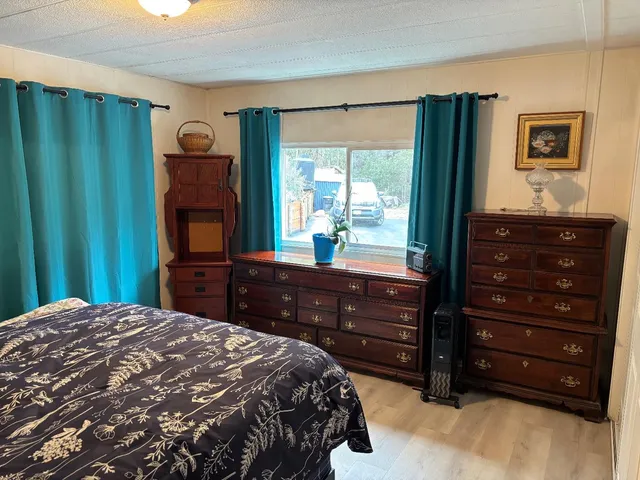 a bedroom with a bed and a dresser