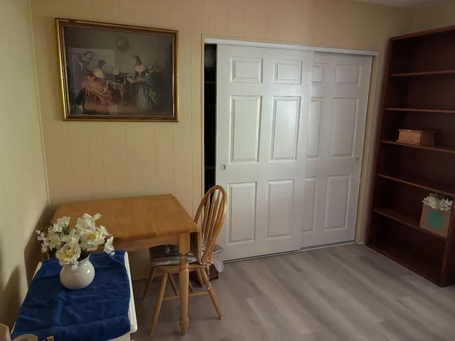 a view of a workspace with furniture and wooden floor