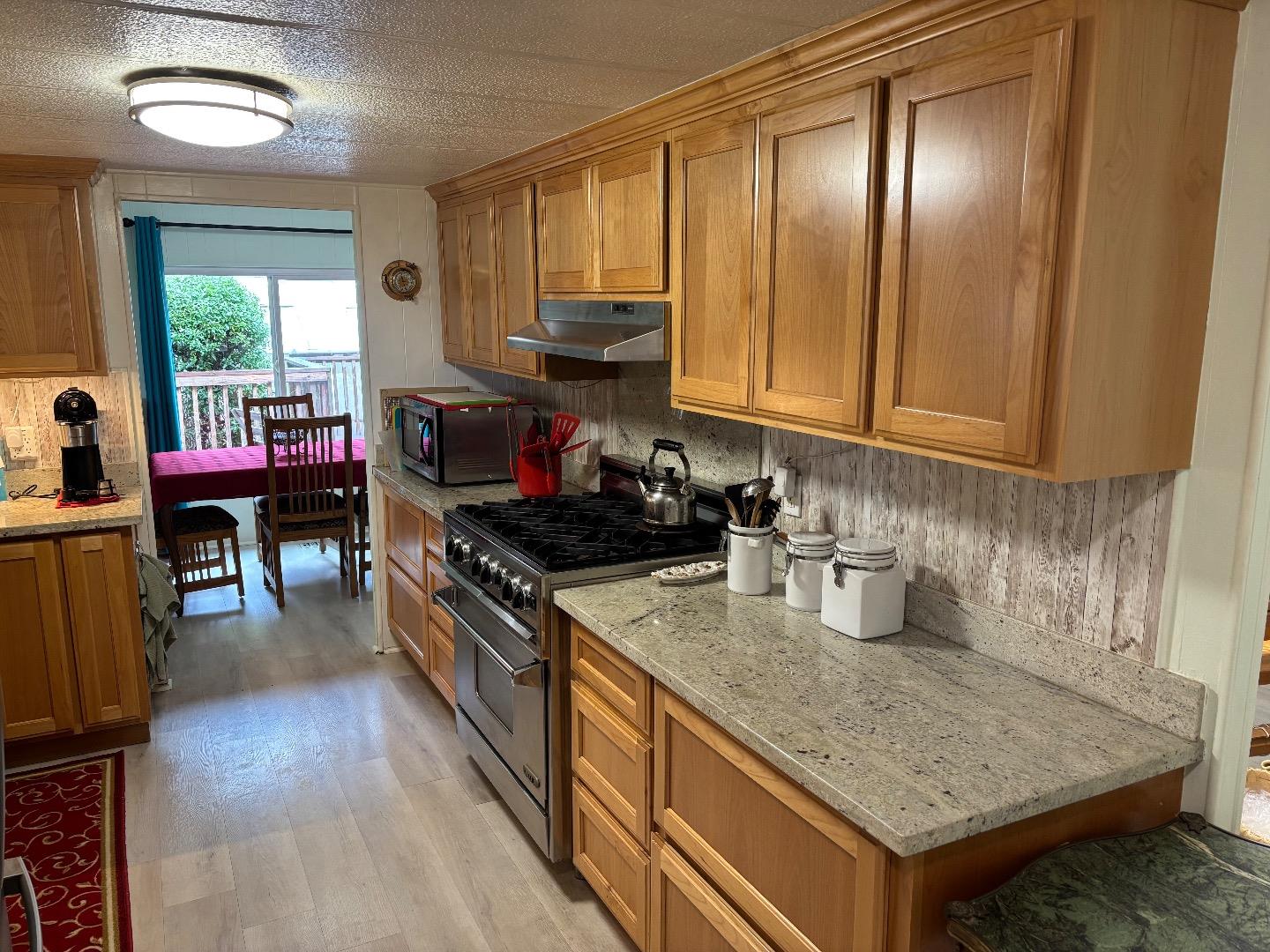 809 Maher Road Salinas, CA 93907 - Photo 14 of 17 a kitchen with stainless steel appliances granite countertop a stove a sink and a microwave