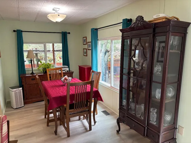 a view of a dining room with furniture and window