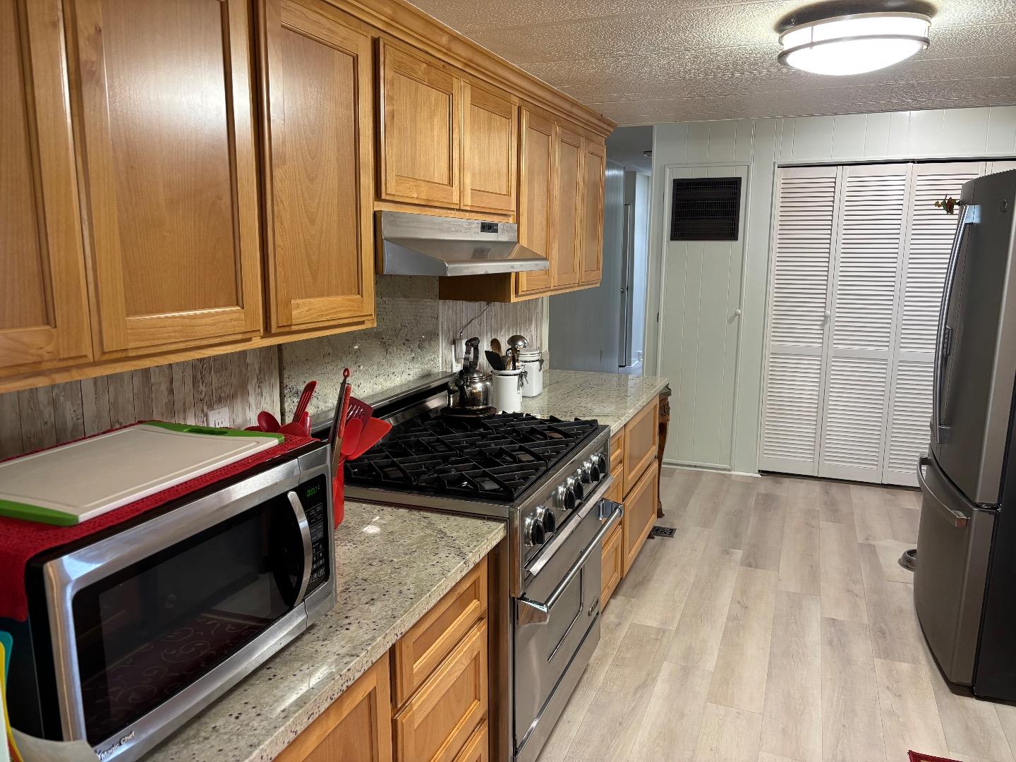 809 Maher Road Salinas, CA 93907 - Photo 10 of 17 a kitchen with granite countertop a stove and a refrigerator