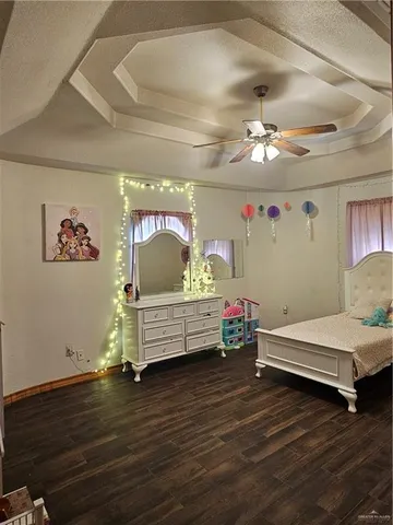a bedroom with furniture and wooden floor