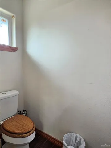 a white toilet sitting next to a window