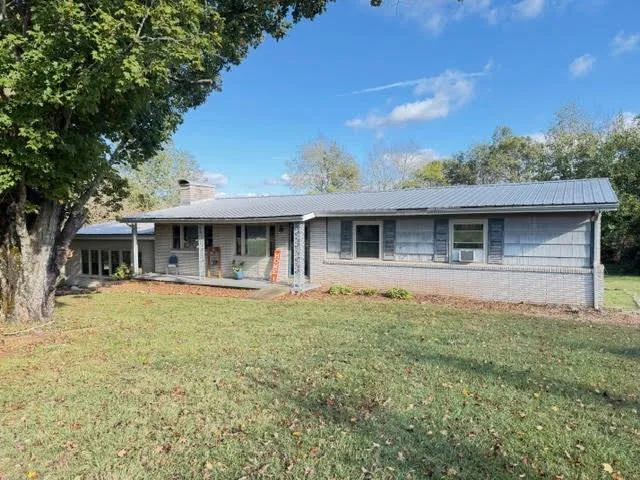 a front view of house with yard and green space