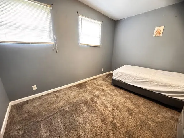 a bedroom with a bed and window