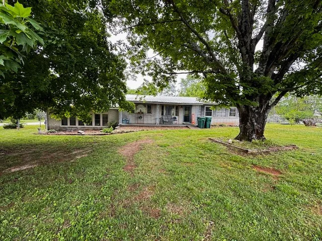 a house view with a sitting space and garden