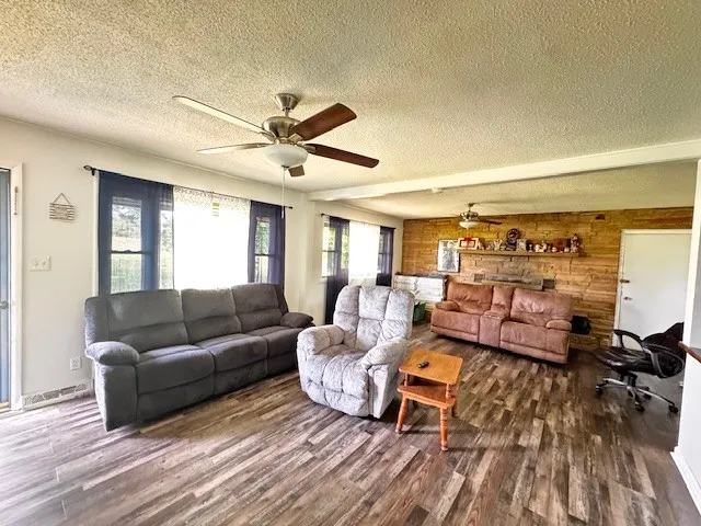 a living room with furniture and a wooden floor
