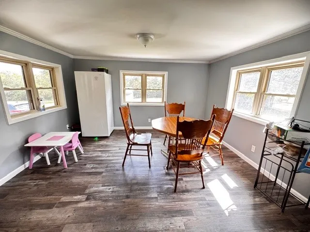 a dining room with furniture and wooden floor