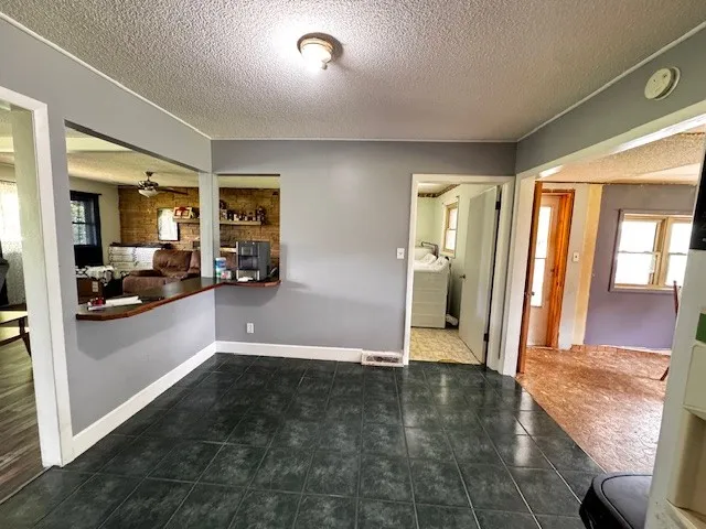 a view of a big room with wooden floor and windows