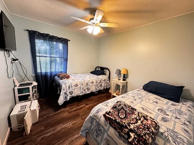 a bedroom with two beds and a flat screen tv