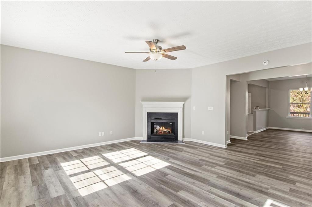 5667 Cascade Run Atlanta, GA 30336 - Photo 13 of 31 wooden floor fireplace and windows in an empty room