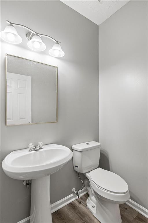 5667 Cascade Run Atlanta, GA 30336 - Photo 14 of 31 a bathroom with a sink a toilet and mirror