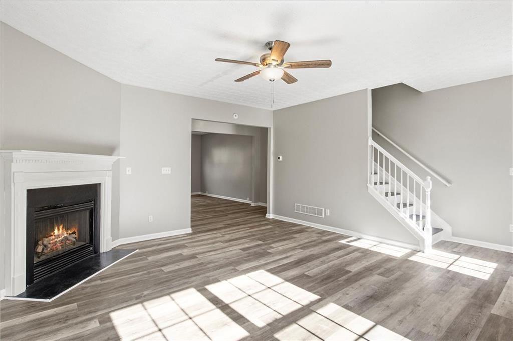 5667 Cascade Run Atlanta, GA 30336 - Photo 2 of 31 a view of an empty room with chandelier fan and fire place