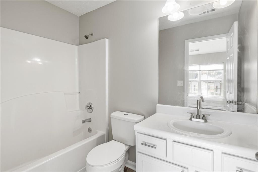 5667 Cascade Run Atlanta, GA 30336 - Photo 22 of 31 a bathroom with a sink toilet vanity and shower