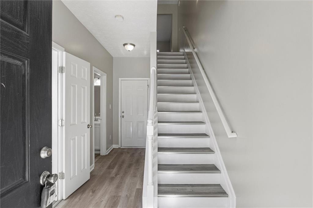 5667 Cascade Run Atlanta, GA 30336 - Photo 4 of 31 a view of a hallway with wooden floor and entryway