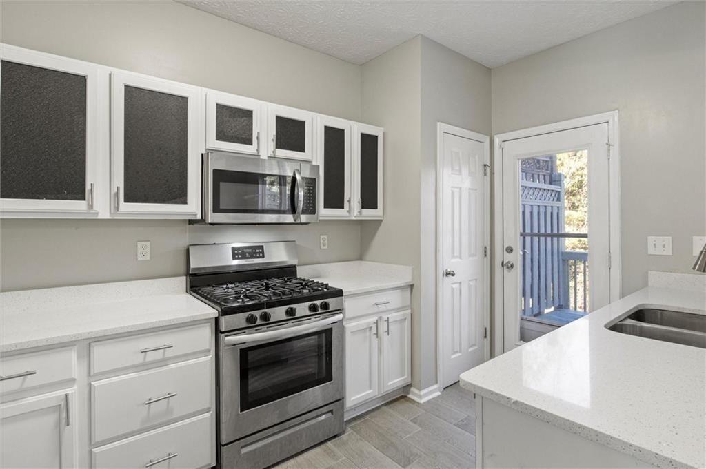 5667 Cascade Run Atlanta, GA 30336 - Photo 10 of 31 a kitchen with cabinets stainless steel appliances and a counter space