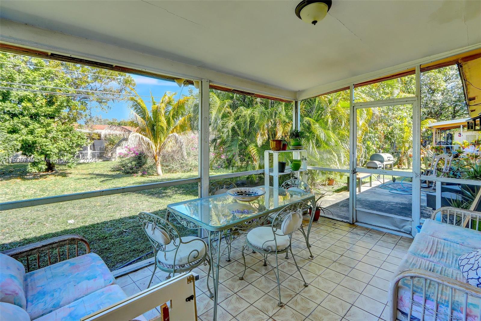 Ives Estates Miami, FL 33179 - Photo 17 of 21 a living room filled with furniture and a floor to ceiling window
