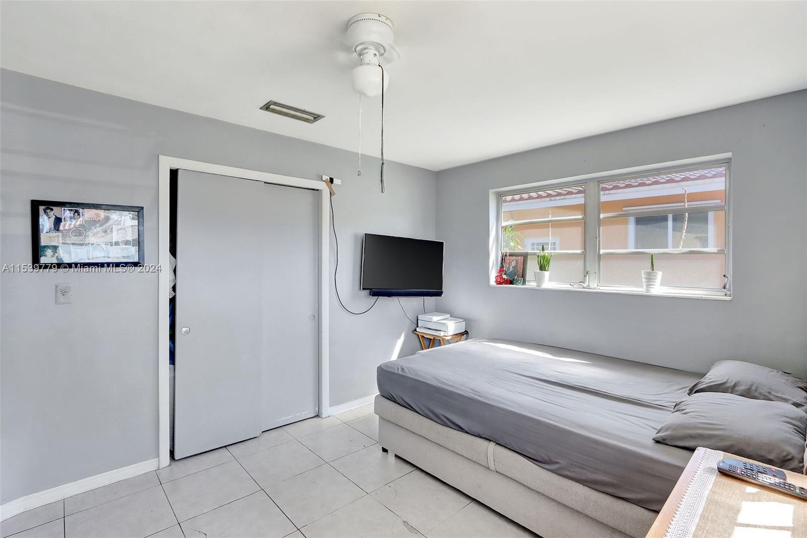 Ives Estates Miami, FL 33179 - Photo 7 of 21 a bedroom with a bed and a flat screen tv