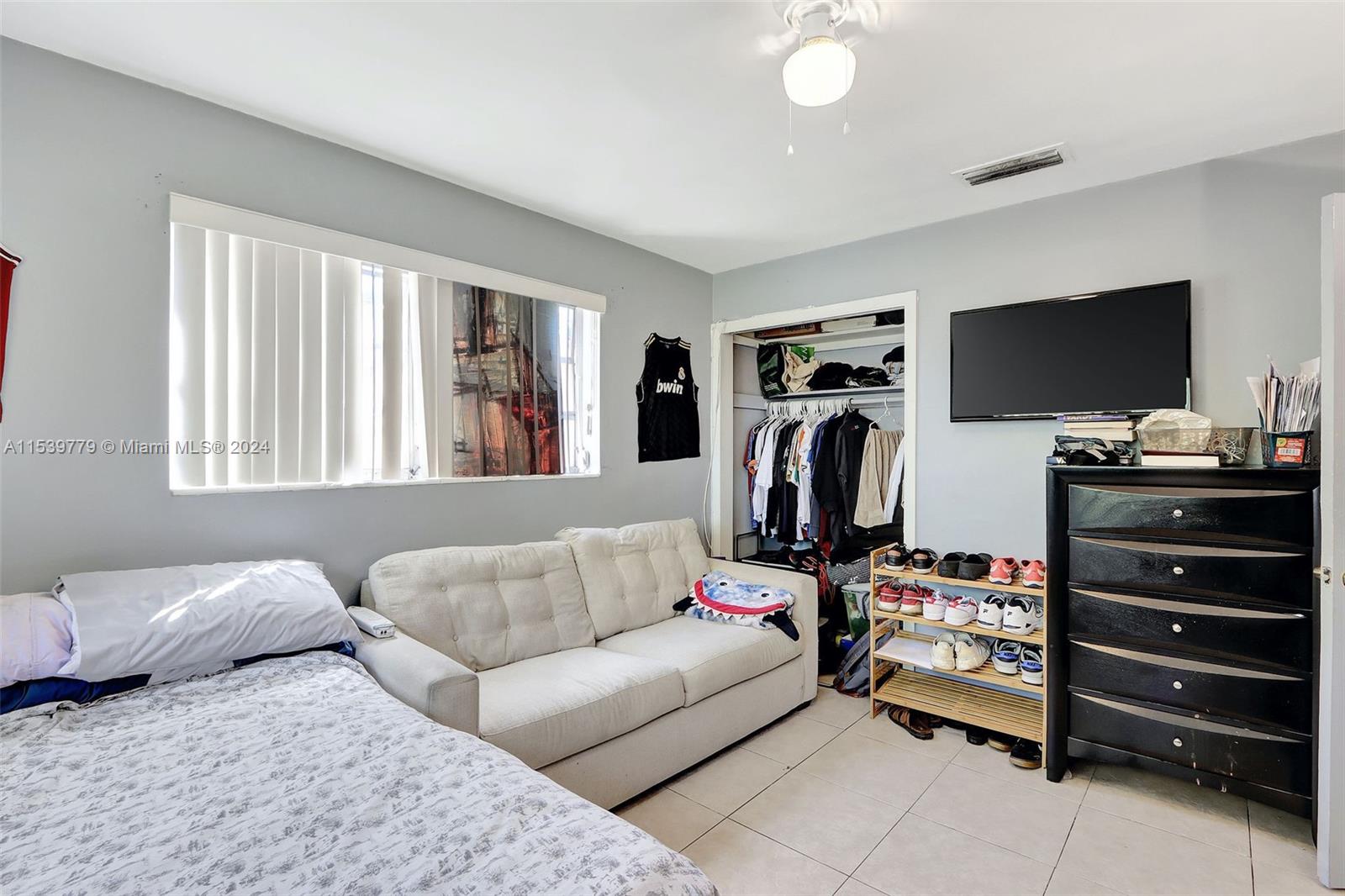 Ives Estates Miami, FL 33179 - Photo 9 of 21 a living room with furniture and a flat screen tv