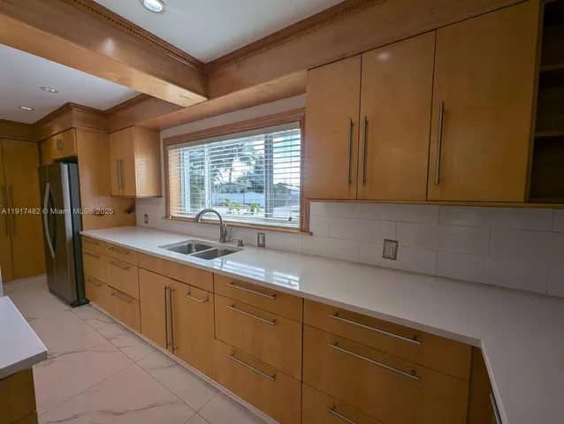 a kitchen with a sink cabinets and window