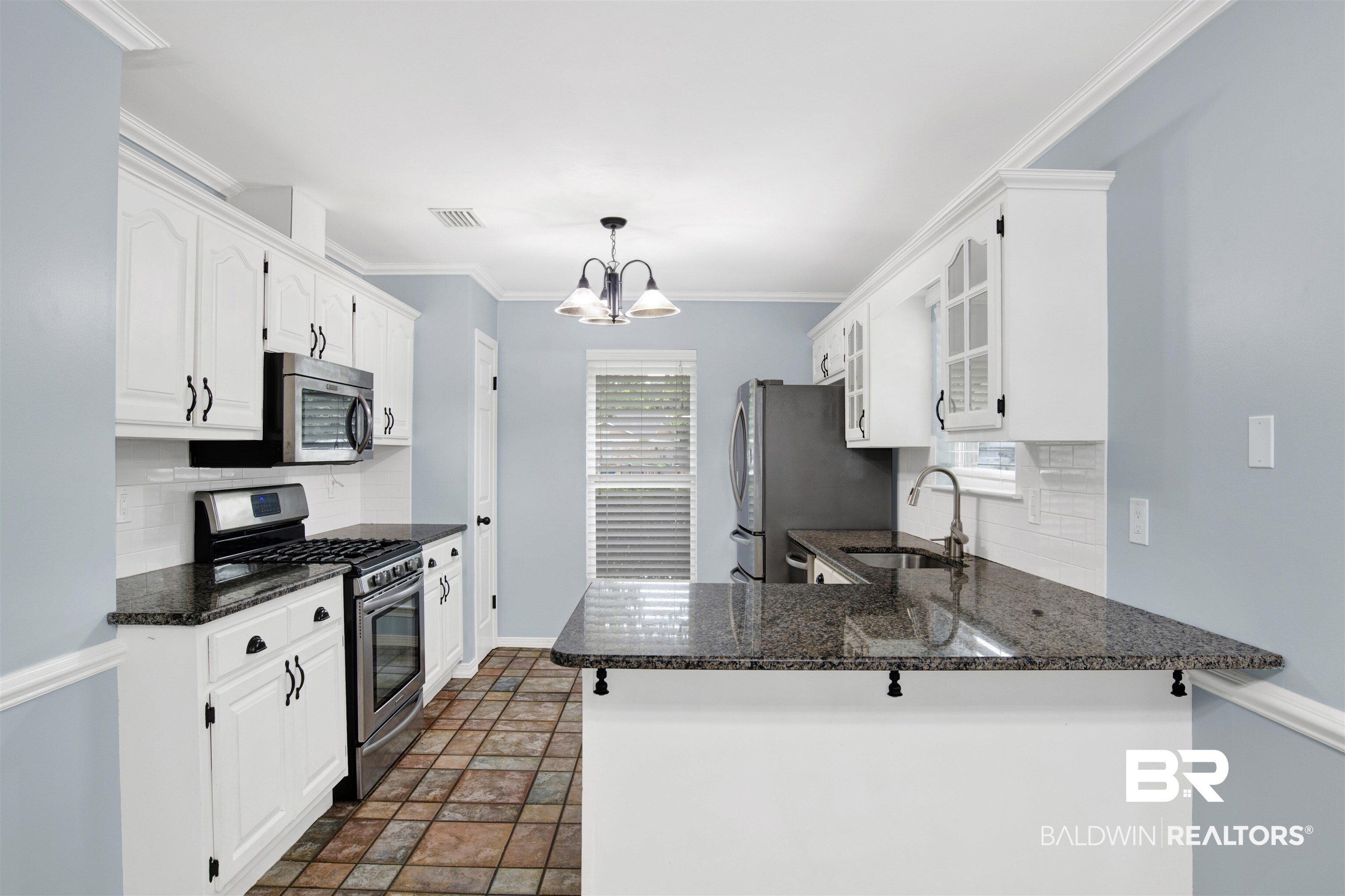 3011 Olde Gate Road Mobile, AL 36695 - Photo 18 of 35 Kitchen featuring appliances with stainless steel finishes, backsplash, a peninsula, glass insert cabinets, and ornamental molding