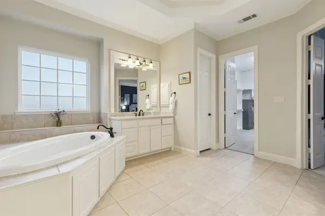 a bathroom with a sink vanity and mirror