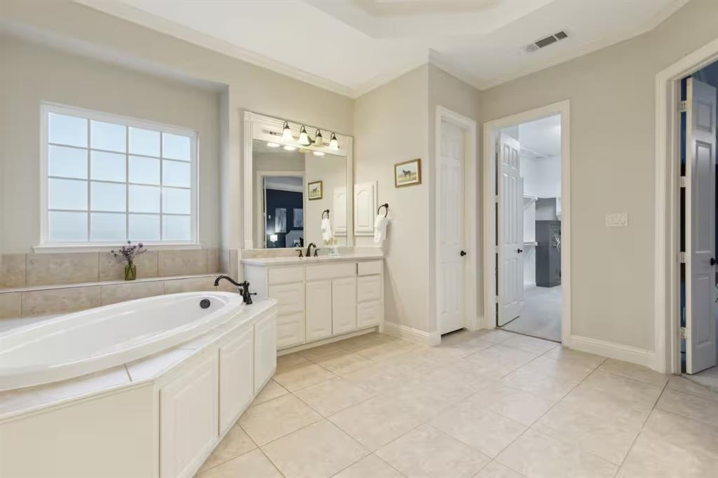 1405 Gateway Boulevard Forney, TX 75126 - Photo 18 of 32 a large white bathroom with a tub sink and mirror