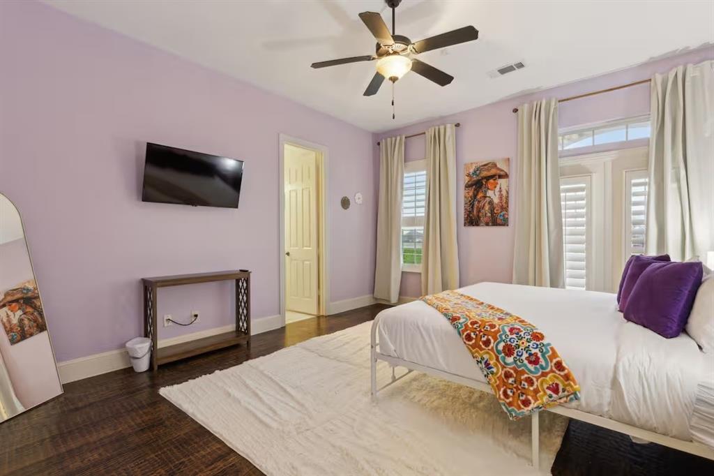 1405 Gateway Boulevard Forney, TX 75126 - Photo 21 of 32 a bedroom with a bed and a flat screen tv