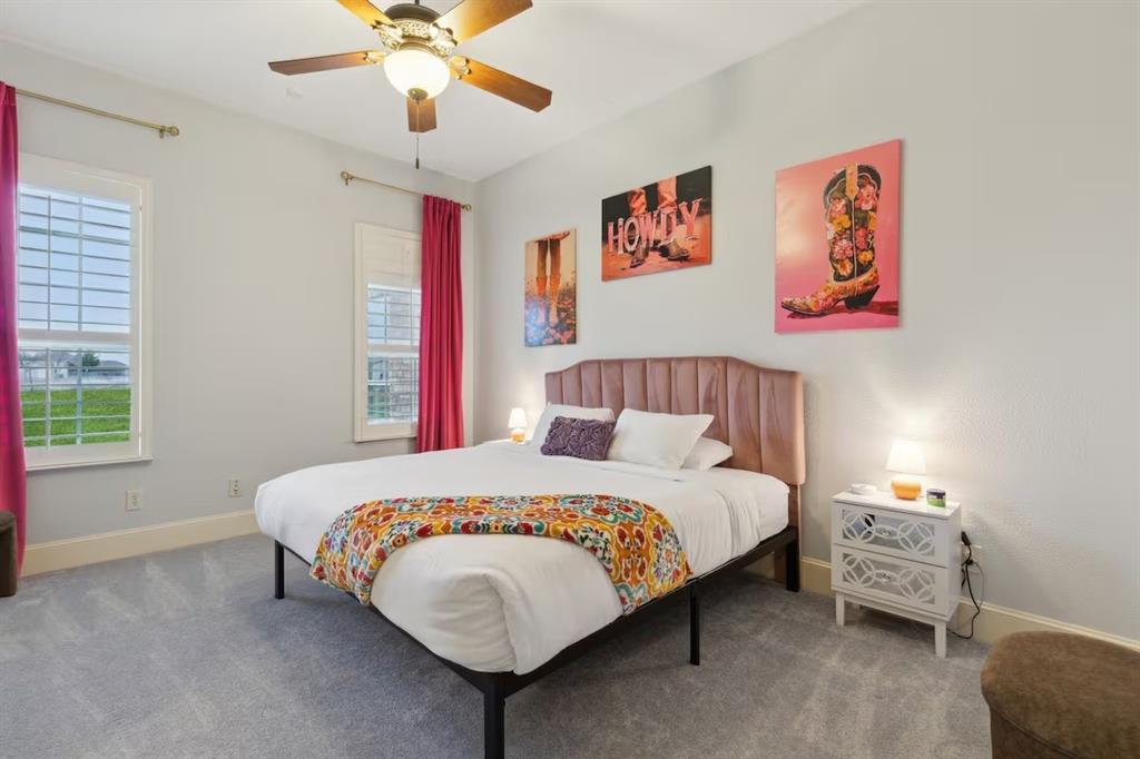 1405 Gateway Boulevard Forney, TX 75126 - Photo 23 of 32 a bedroom with a bed and a chandelier