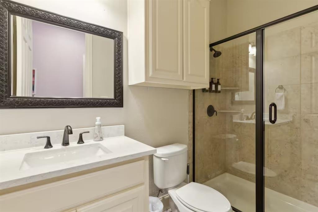 1405 Gateway Boulevard Forney, TX 75126 - Photo 24 of 32 a bathroom with a sink a toilet and shower