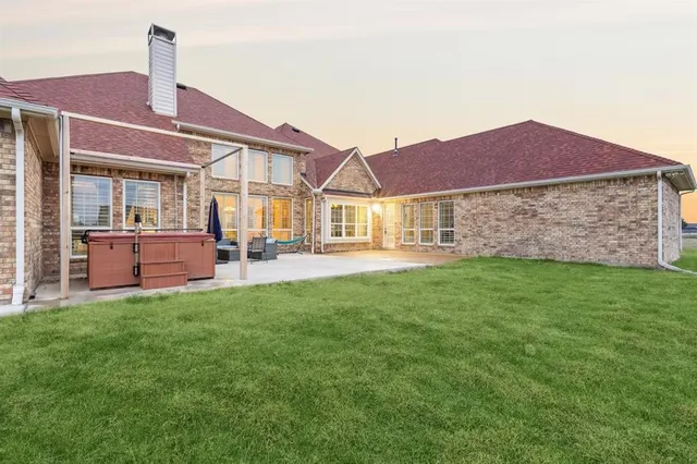 a view of a house with backyard porch and sitting area