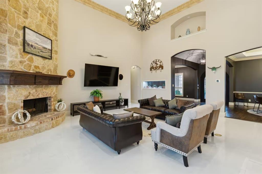 1405 Gateway Boulevard Forney, TX 75126 - Photo 7 of 32 a living room with furniture a fireplace and a flat screen tv