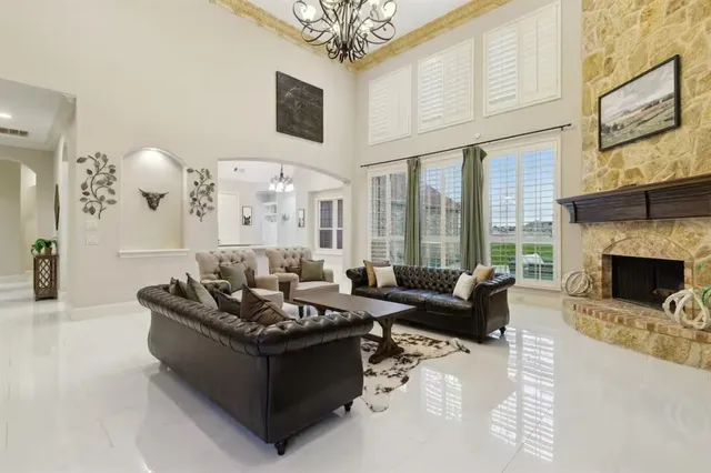 a living room with furniture fireplace and a large window