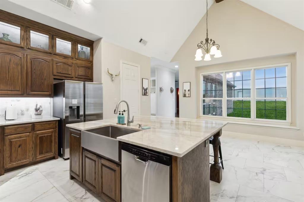1405 Gateway Boulevard Forney, TX 75126 - Photo 9 of 32 a kitchen that has a sink and a stove in it