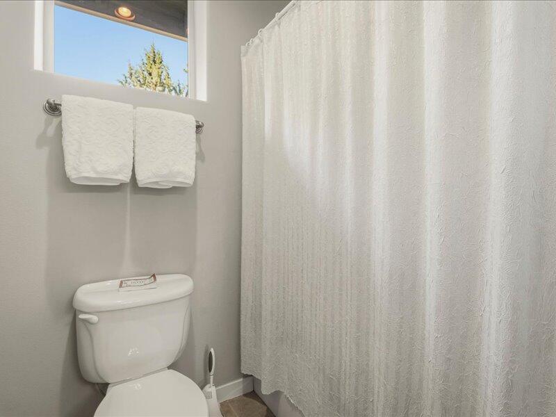 1378 Highland View Loop Redmond, OR 97756 - Photo 41 of 98 a white toilet sitting next to a shower curtain