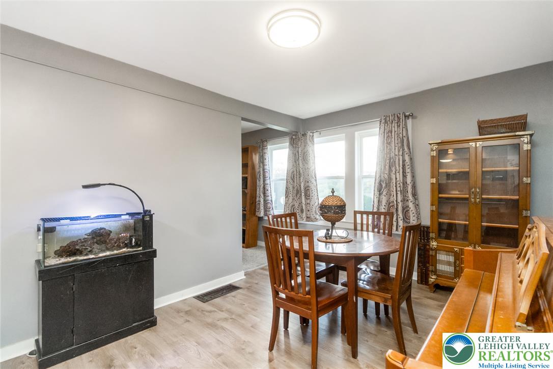 506 Richmond Road Bangor, PA 18013 - Photo 17 of 43 Gleaming LVP flooring and classic window frames define this welcoming dining area.