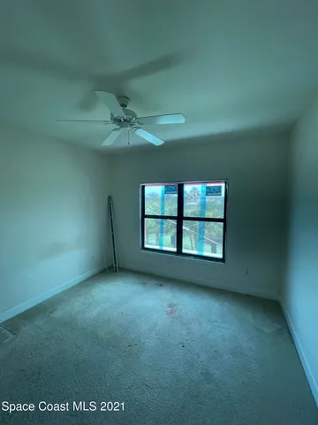 an empty room with a empty space and windows
