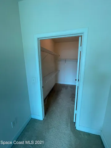 an empty room with a empty space and windows