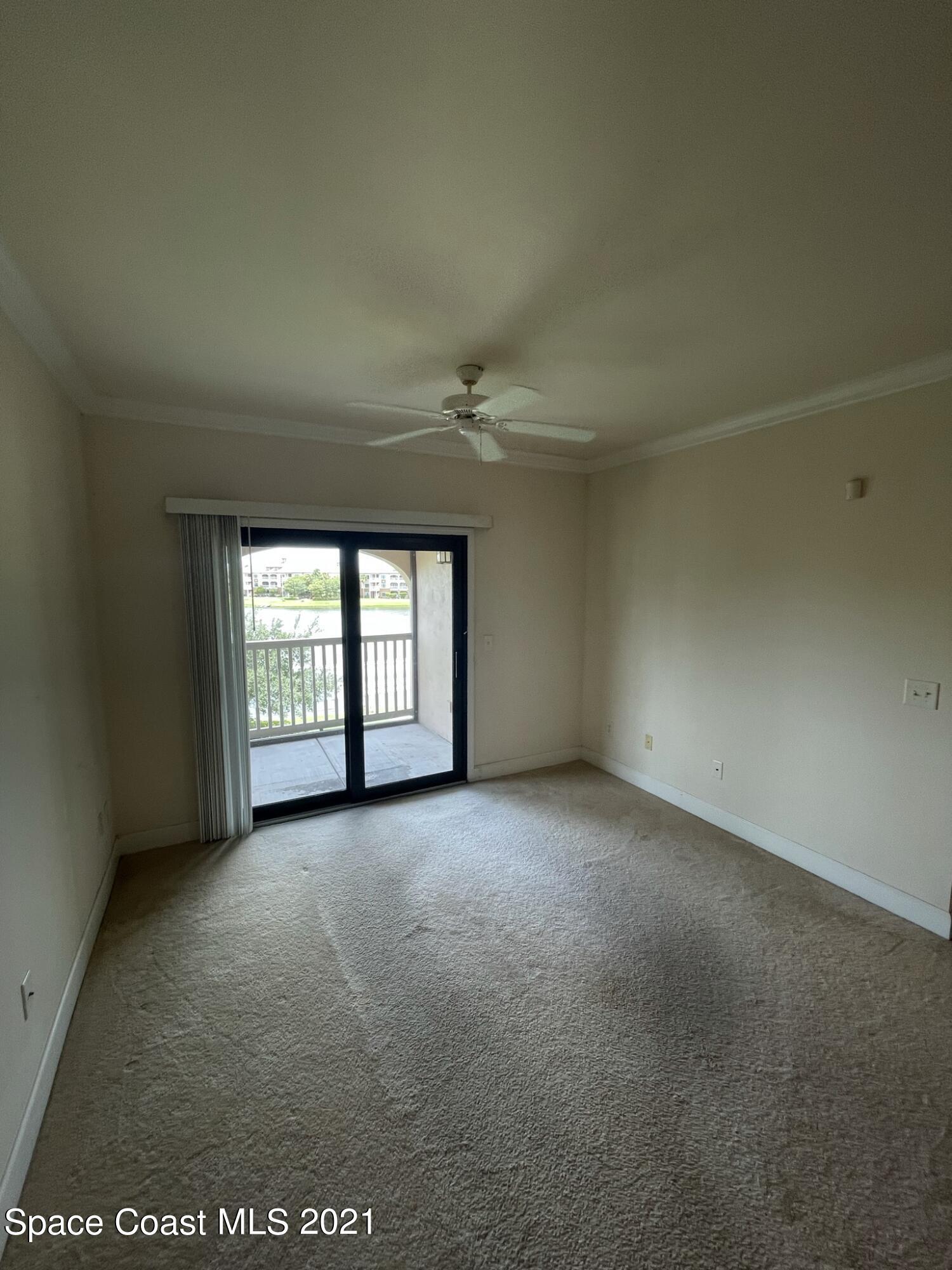 6411 Borasco Drive, Unit 319 Melbourne, FL 32940 - Photo 13 of 27 an empty room with a empty space and windows