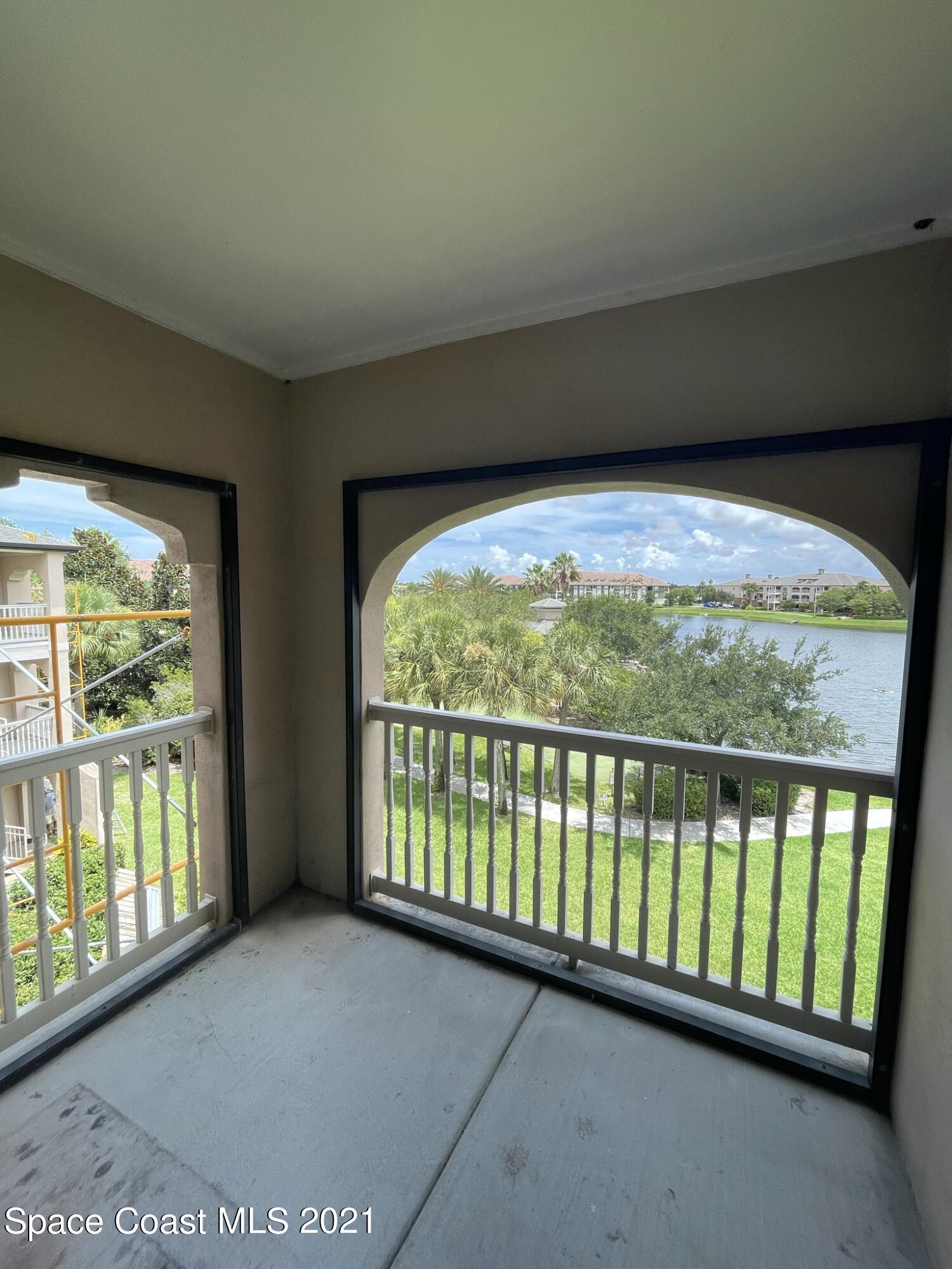 6411 Borasco Drive, Unit 319 Melbourne, FL 32940 - Photo 14 of 27 a view of an empty room with a large window