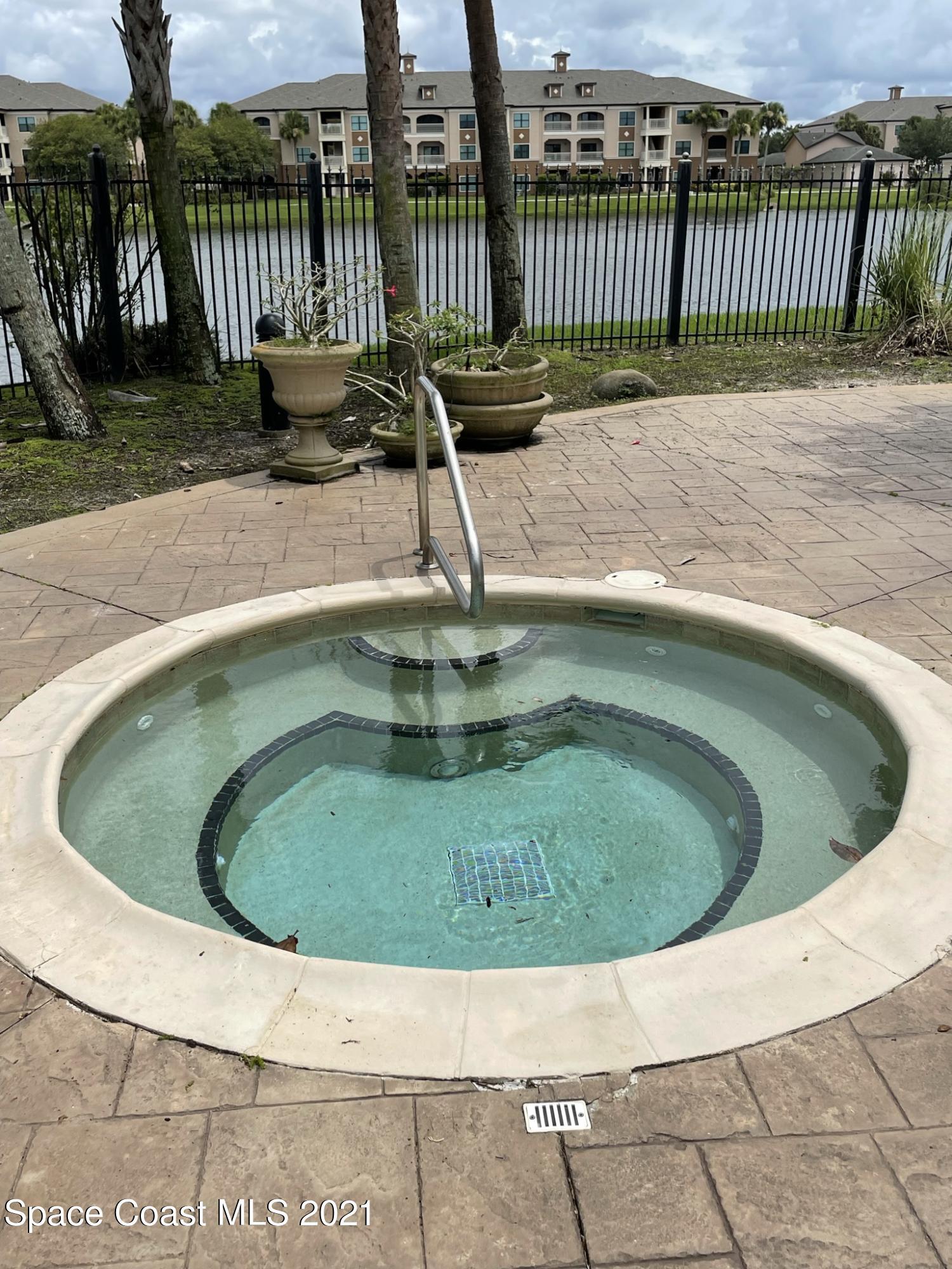 6411 Borasco Drive, Unit 319 Melbourne, FL 32940 - Photo 22 of 27 a view of a swimming pool with a small swimming pool
