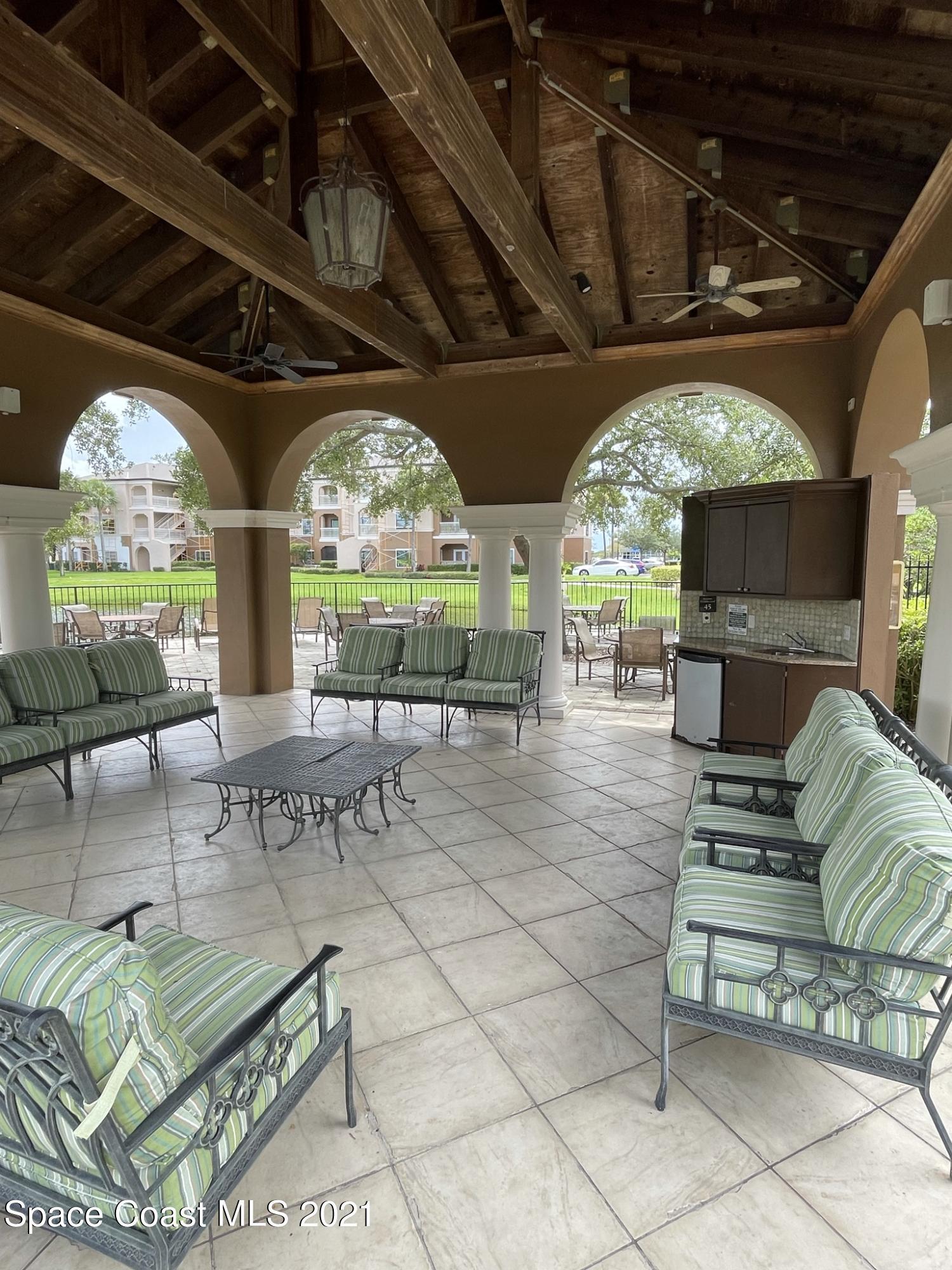 6411 Borasco Drive, Unit 319 Melbourne, FL 32940 - Photo 23 of 27 a view of a porch with furniture and a fireplace